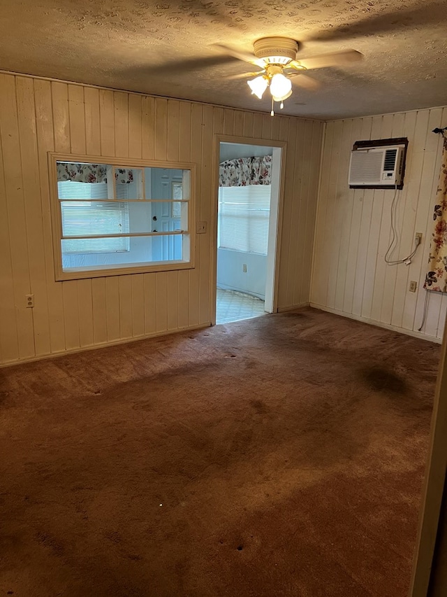 1418N Hendrix St, Diboll, TX 75941 - carpeted empty room with a textured ceiling, wood walls, a wall mounted air conditioner, and ceiling fan