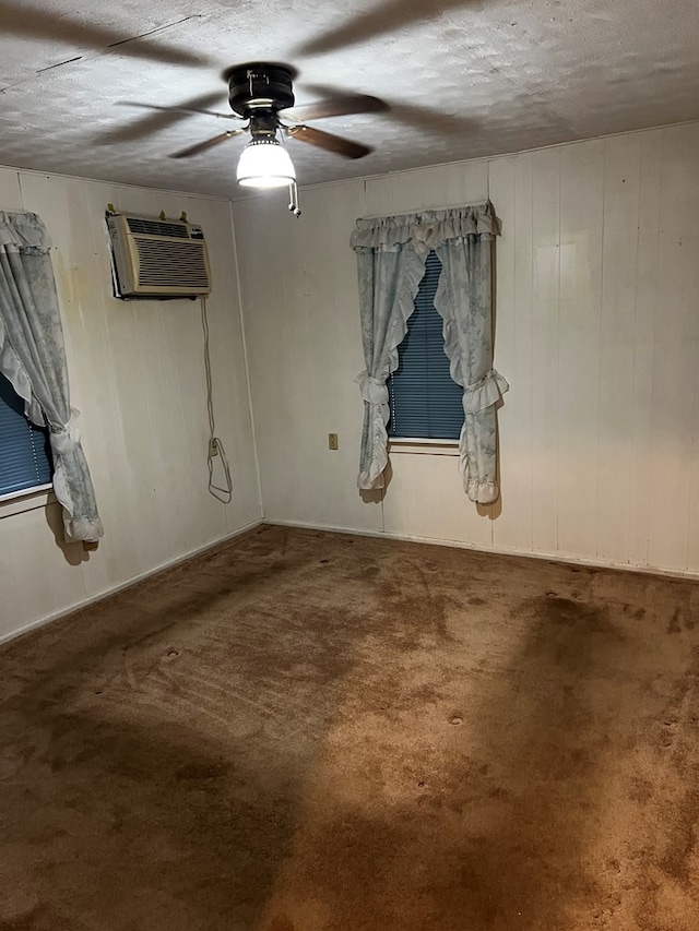 1418N Hendrix St, Diboll, TX 75941 - carpeted spare room featuring an AC wall unit, ceiling fan, a textured ceiling, and wooden walls
