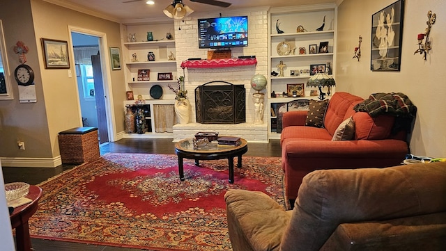 622 Egret Dr, Nacogdoches, TX 75964 - living area with a ceiling fan, wood finished floors, baseboards, ornamental molding, and built in shelves