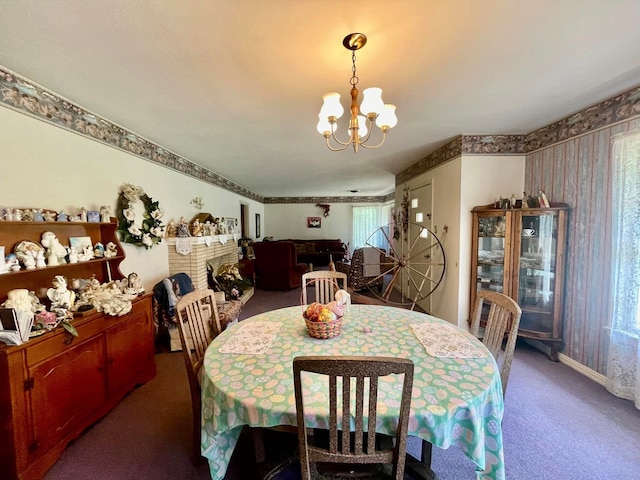 dining space featuring carpet and an inviting chandelier