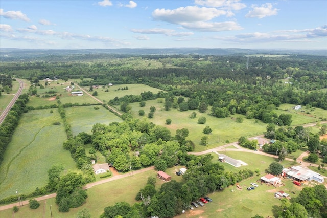 drone / aerial view featuring a rural view and a wooded view