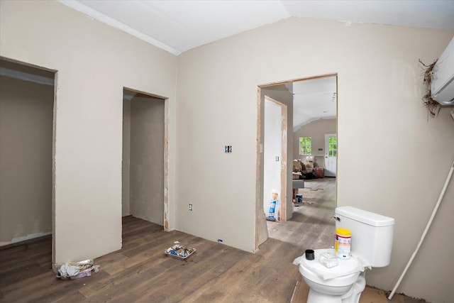 bedroom with vaulted ceiling and wood finished floors