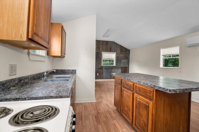 kitchen featuring dark countertops, white range with electric stovetop, light wood finished floors, a wall mounted air conditioner, and vaulted ceiling