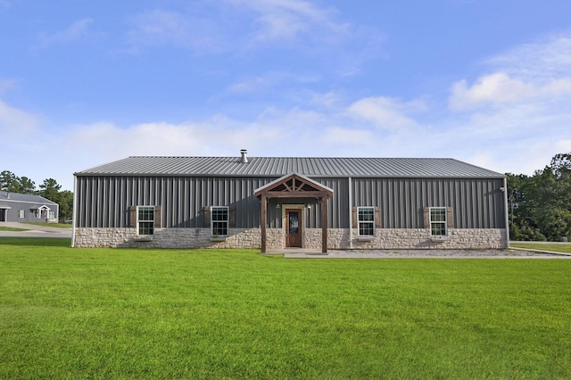 rear view of property featuring a lawn