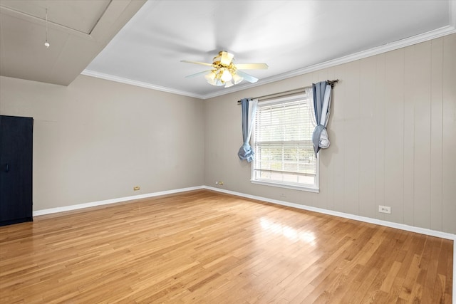 unfurnished room with wooden walls, light hardwood / wood-style flooring, ceiling fan, and ornamental molding