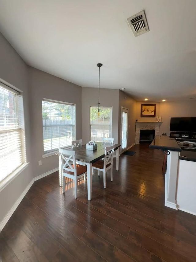 571 Ashwood Bnd, Lufkin, TX 75904 - dining area featuring a fireplace, dark wood finished floors, baseboards, and recessed lighting