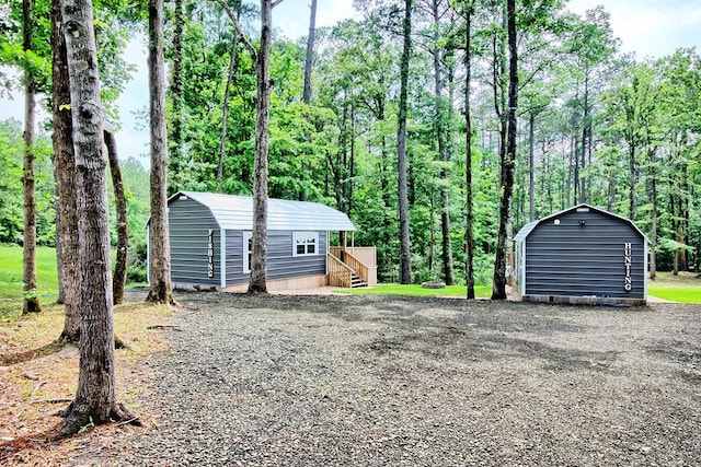 exterior space with a storage shed and a wooden deck