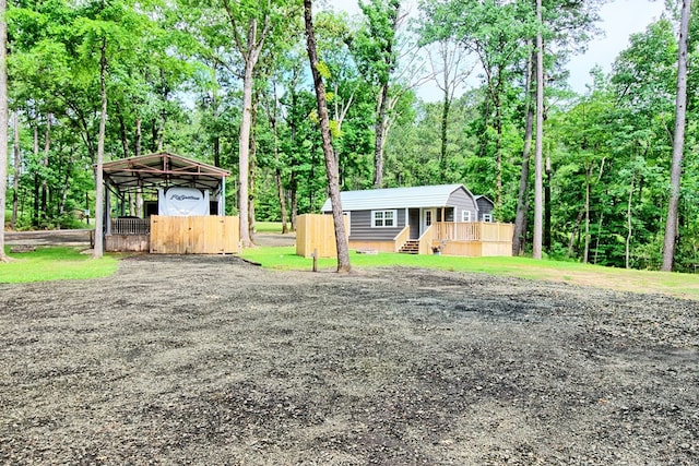 view of front facade featuring an outbuilding and a carport