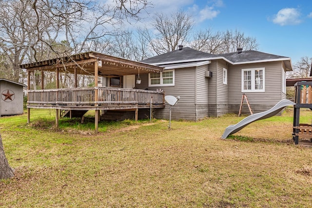 rear view of house with a lawn and a wooden deck