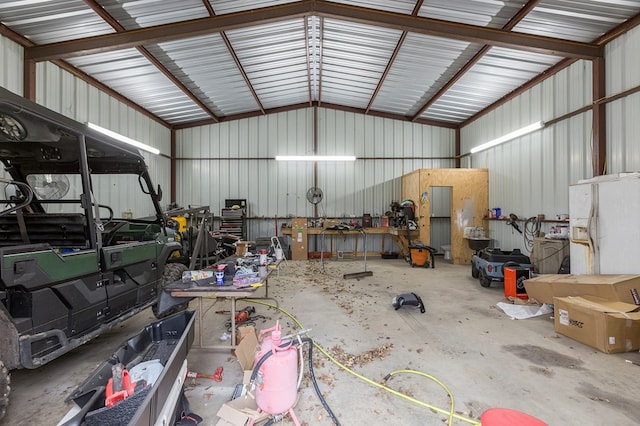 garage with metal wall and white refrigerator with ice dispenser