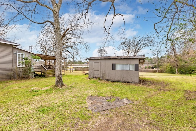 view of yard featuring an outbuilding and a deck