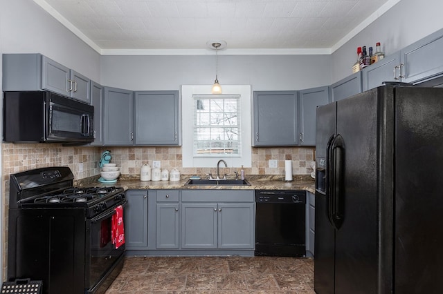 kitchen featuring black appliances, tasteful backsplash, gray cabinets, and a sink