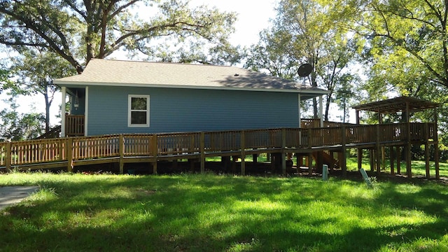 back of house featuring a lawn and a wooden deck