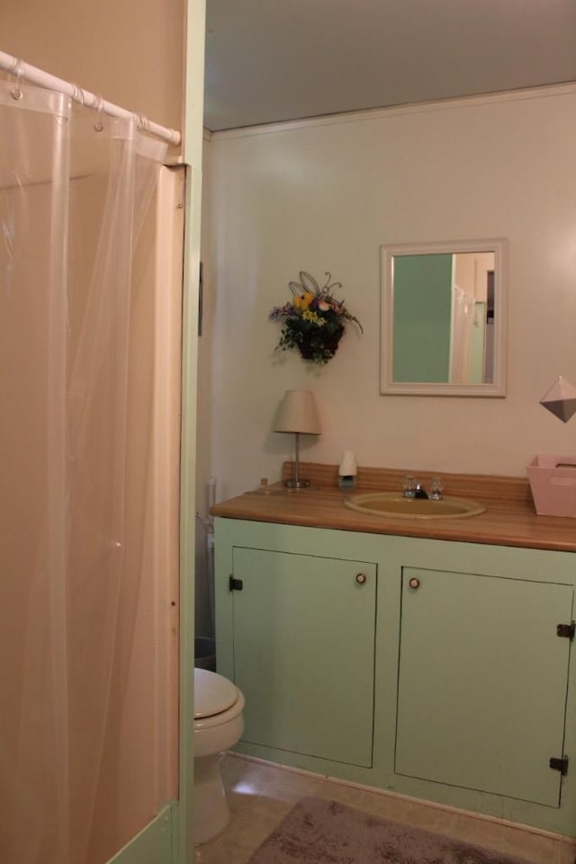 bathroom featuring tile patterned floors, vanity, and toilet