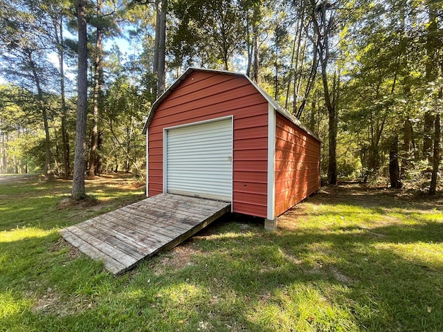 view of outbuilding featuring a yard and a garage