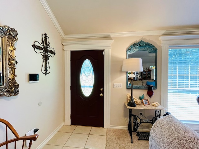 tiled foyer entrance featuring ornamental molding