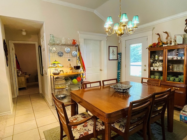 tiled dining room with a chandelier, vaulted ceiling, and ornamental molding