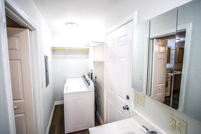 washroom with dark wood-type flooring and washer and dryer