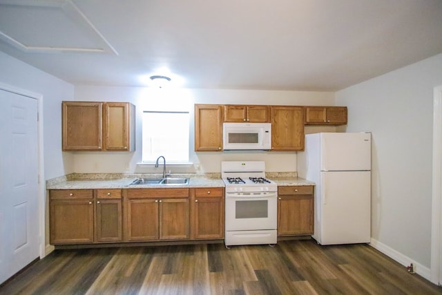 kitchen featuring white appliances, dark hardwood / wood-style floors, and sink