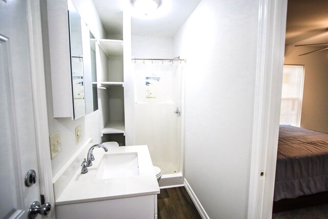 bathroom with hardwood / wood-style flooring, vanity, curtained shower, and ceiling fan