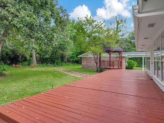 deck featuring a gazebo and a yard