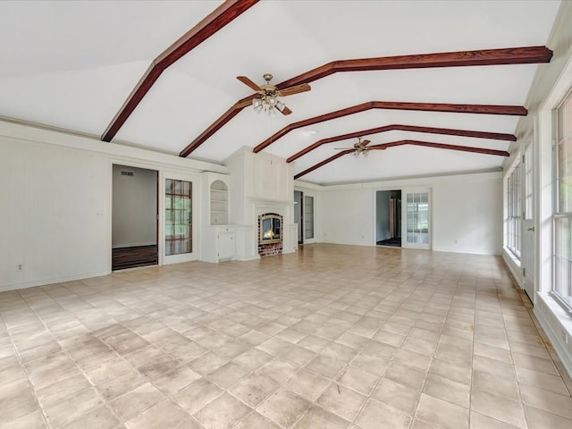 unfurnished living room featuring lofted ceiling with beams, ceiling fan, and a fireplace