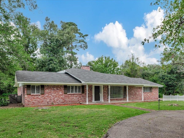 ranch-style home with a front lawn