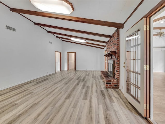 unfurnished living room with high vaulted ceiling, light hardwood / wood-style flooring, a brick fireplace, ceiling fan, and beam ceiling