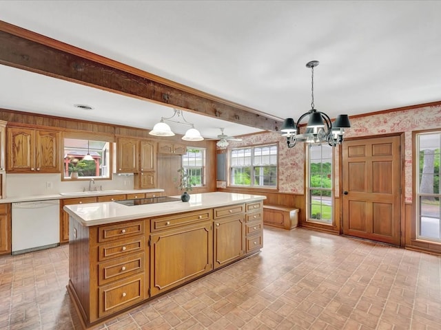 kitchen featuring white dishwasher, decorative light fixtures, black electric stovetop, and plenty of natural light