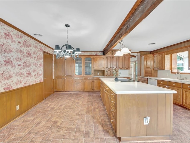 kitchen with dishwasher, sink, an inviting chandelier, pendant lighting, and ornamental molding