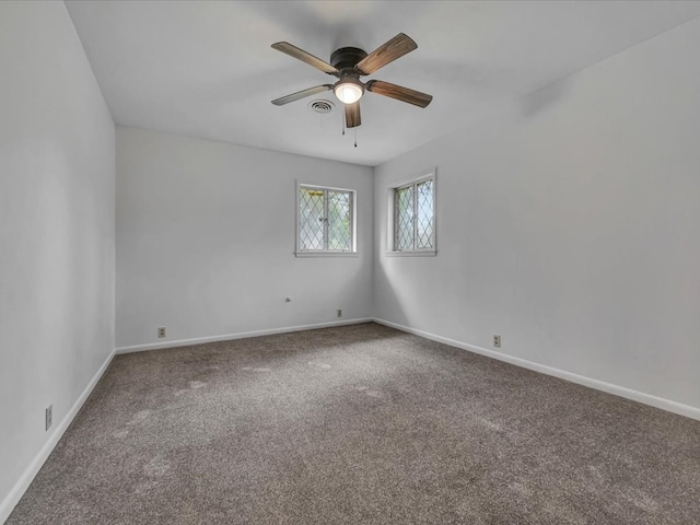 carpeted spare room with ceiling fan