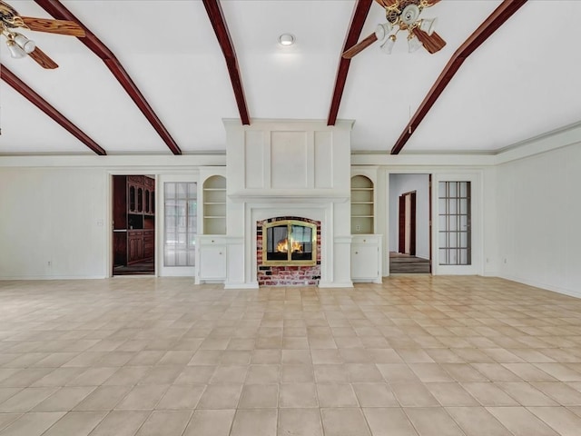 unfurnished living room with built in shelves, lofted ceiling with beams, ceiling fan, and a brick fireplace