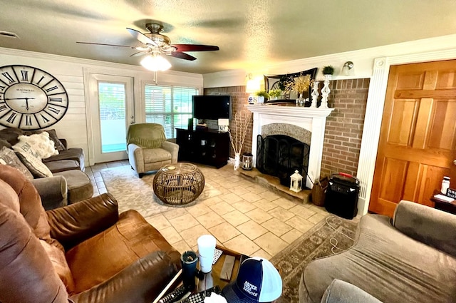 708 Card Dr, Lufkin, TX 75901 - tiled living room with a ceiling fan, a textured ceiling, a fireplace with raised hearth, and ornamental molding