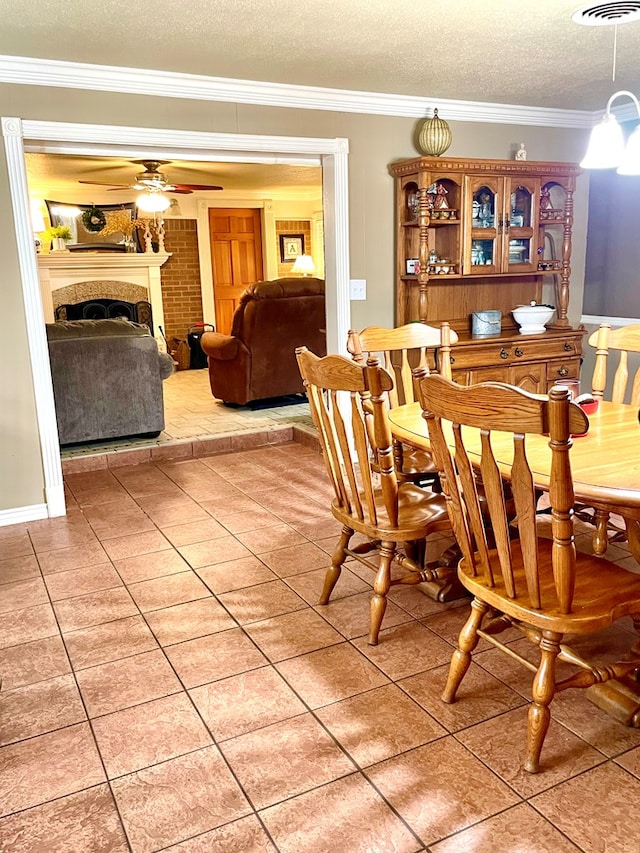 708 Card Dr, Lufkin, TX 75901 - dining room featuring crown molding, a textured ceiling, and light tile patterned floors