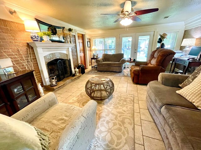 708 Card Dr, Lufkin, TX 75901 - living area featuring ceiling fan, a textured ceiling, visible vents, a tiled fireplace, and ornamental molding