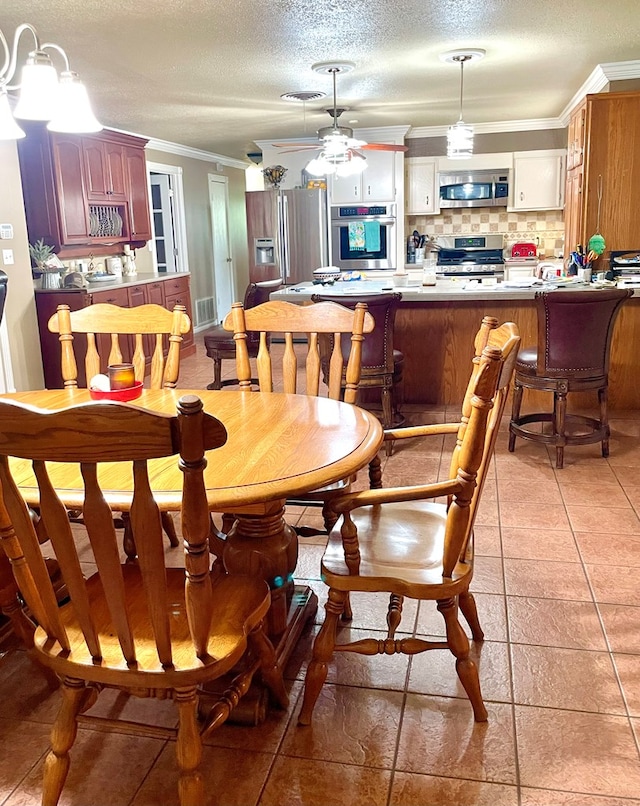 708 Card Dr, Lufkin, TX 75901 - dining room with crown molding, a ceiling fan, and a textured ceiling