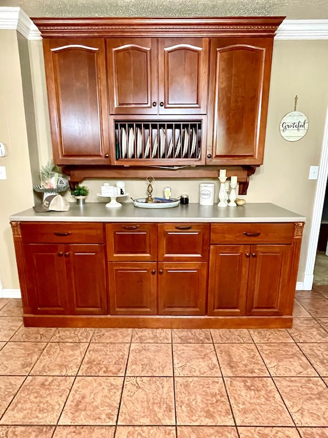 708 Card Dr, Lufkin, TX 75901 - bar with crown molding, baseboards, and light tile patterned flooring