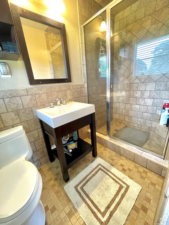 708 Card Dr, Lufkin, TX 75901 - full bath featuring vanity, a stall shower, toilet, and tile walls