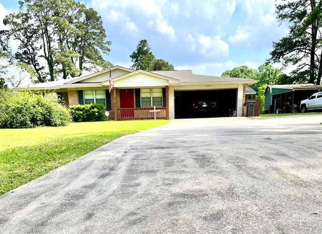 708 Card Dr, Lufkin, TX 75901 - ranch-style home featuring an attached garage, a front lawn, driveway, and a porch