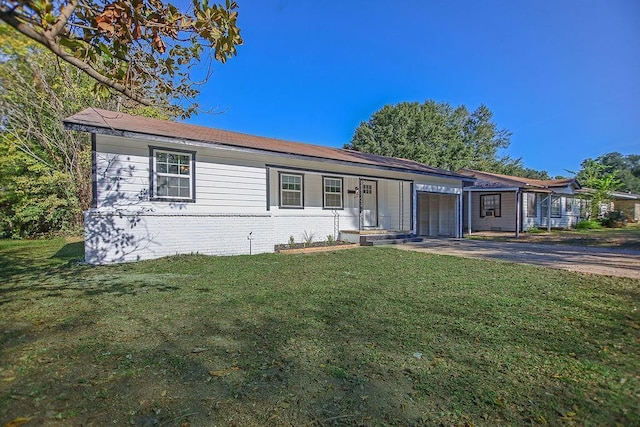 single story home featuring a garage and a front lawn