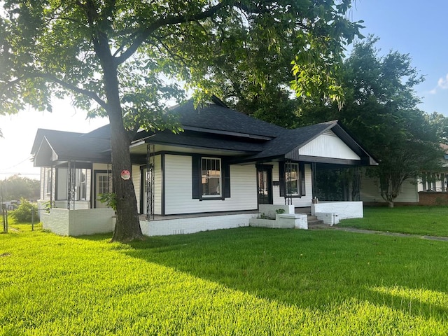 505 N 1st St, Lufkin, TX 75901 - view of front of house featuring a front lawn, a shingled roof, and covered porch