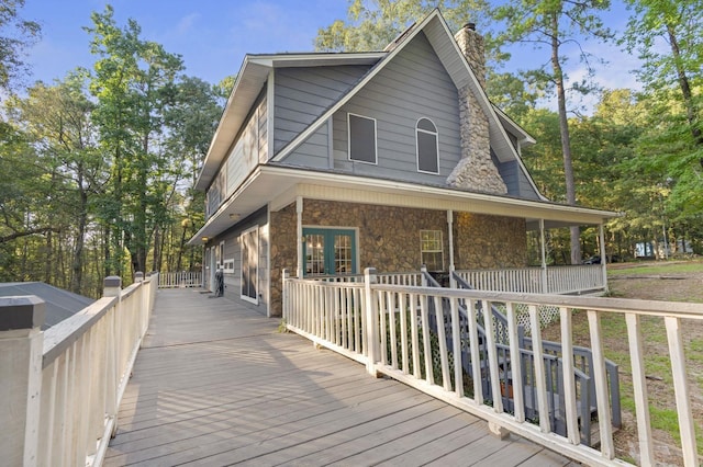 7332 Fm 252, Jasper, TX 75951 - view of property exterior featuring stone siding, a chimney, and a porch