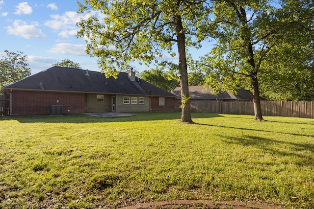 126 Lewellin Pl, Lufkin, TX 75904 - rear view of property with brick siding, a chimney, and a patio