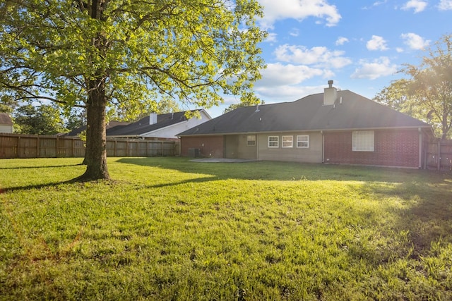 126 Lewellin Pl, Lufkin, TX 75904 - rear view of house featuring a fenced backyard, brick siding, and a chimney