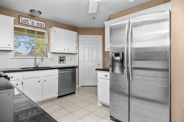 126 Lewellin Pl, Lufkin, TX 75904 - kitchen featuring stainless steel appliances, white cabinetry, a ceiling fan, dark countertops, and light tile patterned floors