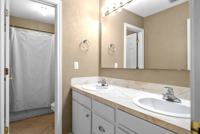 126 Lewellin Pl, Lufkin, TX 75904 - bathroom with a textured wall, double vanity, tile patterned flooring, and a shower with curtain