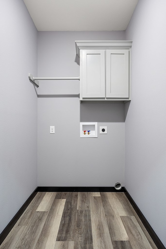 laundry area featuring hookup for an electric dryer, wood-type flooring, hookup for a washing machine, and cabinets