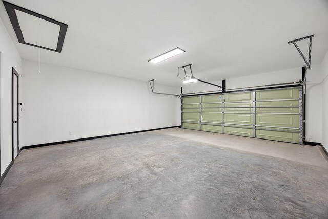119 Park Pl, Lufkin, TX 75901 - garage featuring a garage door opener and baseboards