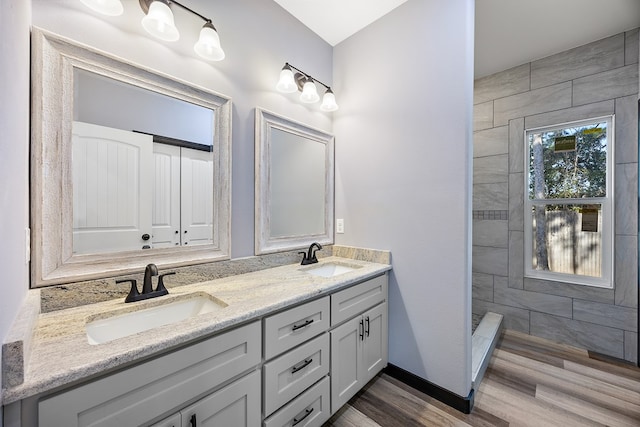 119 Park Pl, Lufkin, TX 75901 - bathroom featuring double vanity, wood finished floors, and tiled shower