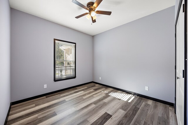 empty room featuring ceiling fan and light hardwood / wood-style flooring